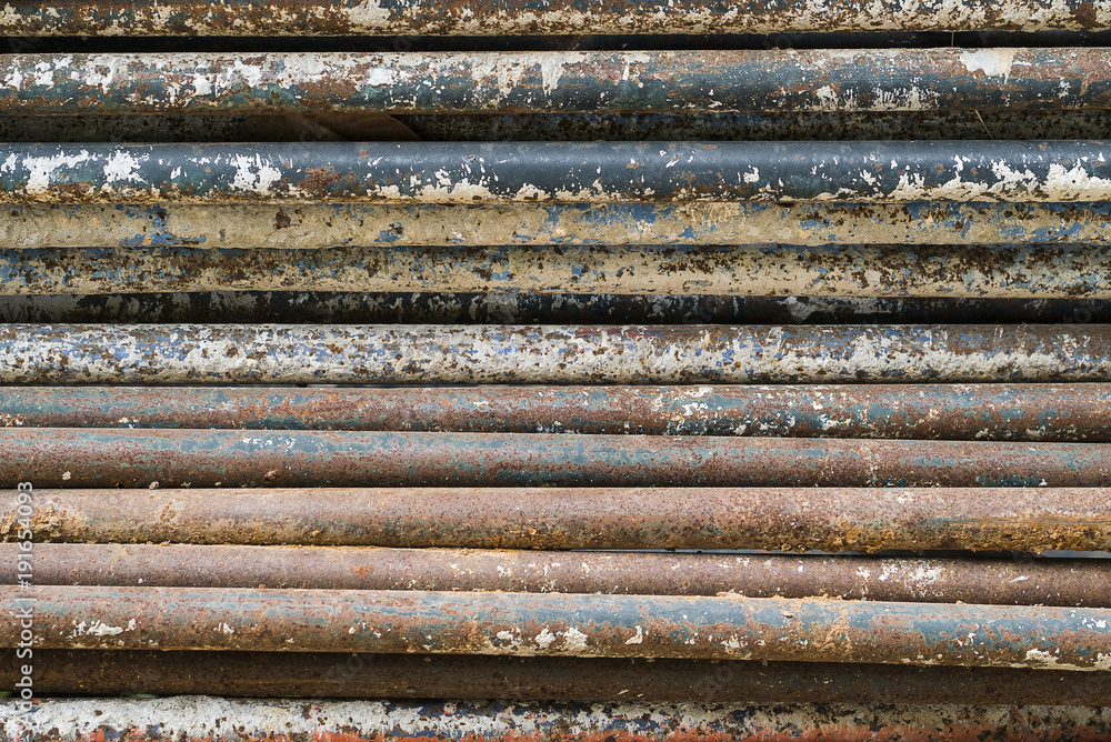 Old rusted iron tubes background. overlap and layer.