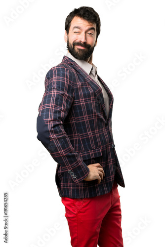 Well dressed man winking on white background © luismolinero