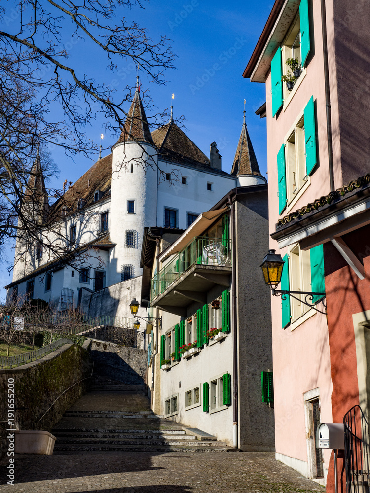 The medieval Nyon Castle in a sunny day, Nyon, Switzerland, 2018, january. White towers, blue sky