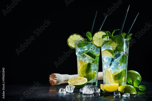 Two glasses of mojito cocktail with fresh lime and mint