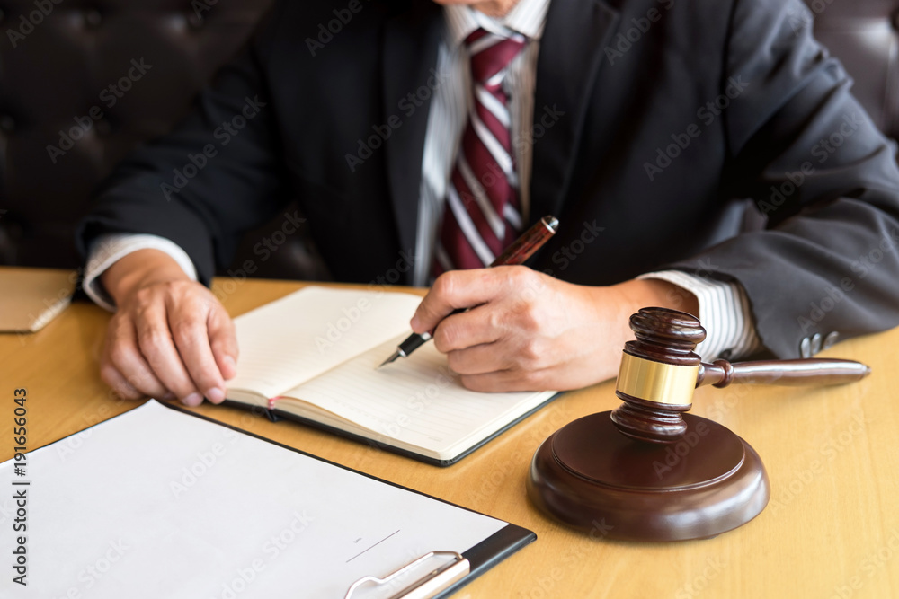 Judge gavel with Justice lawyers, Businessman in suit or lawyer working on a documents. Legal law, advice and justice concept Judge gavel with Justice lawyers, Businessman in suit or lawyer working on a documents. Legal law, advice and justice concept