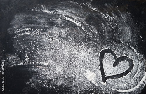 Murais de parede Baking background with heart shape and flour on the dark table