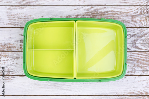 Empty lunch box on wooden table, top view