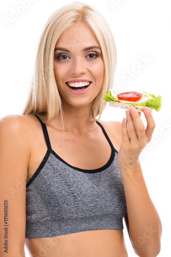 Woman in sportswear with vegetarian sandwich, isolated