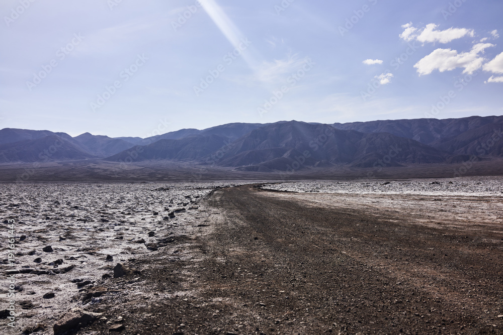 Dry Arid Desert Terrain and Mountains in the Distance Dry Arid Desert Terrain and Mountains in the Distance