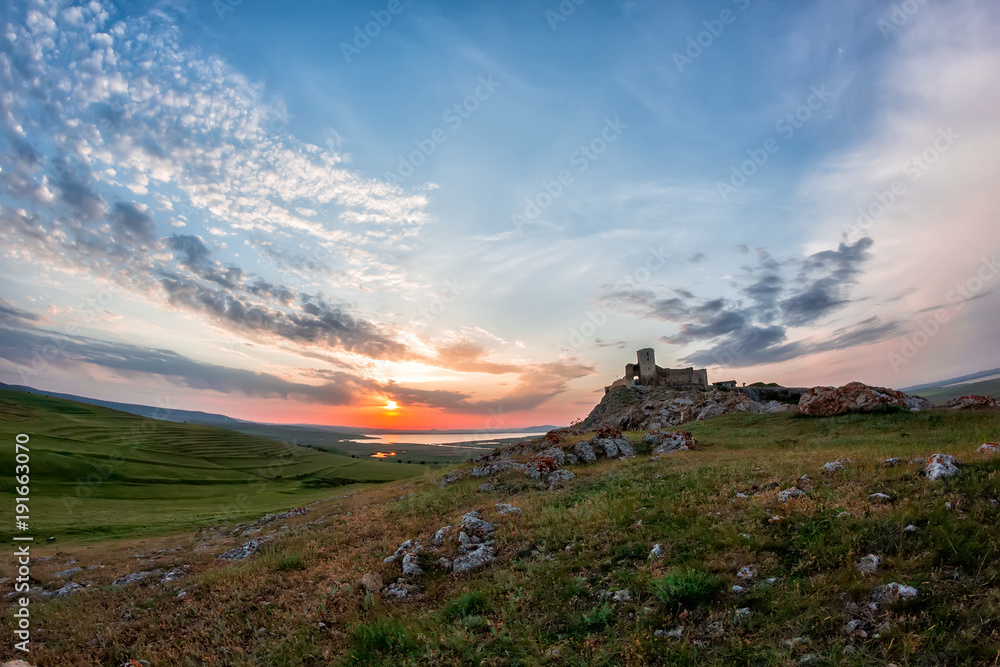 Beautiful landscape and a sunset sky over Enisala old stronghold citadel,Dobrogea,Romania