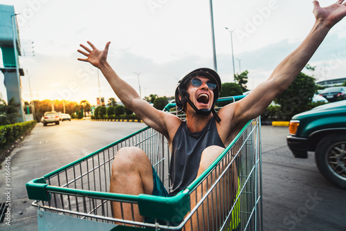 Emotional man in shopping cart photo