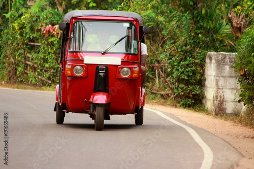red autorickshaw on the road