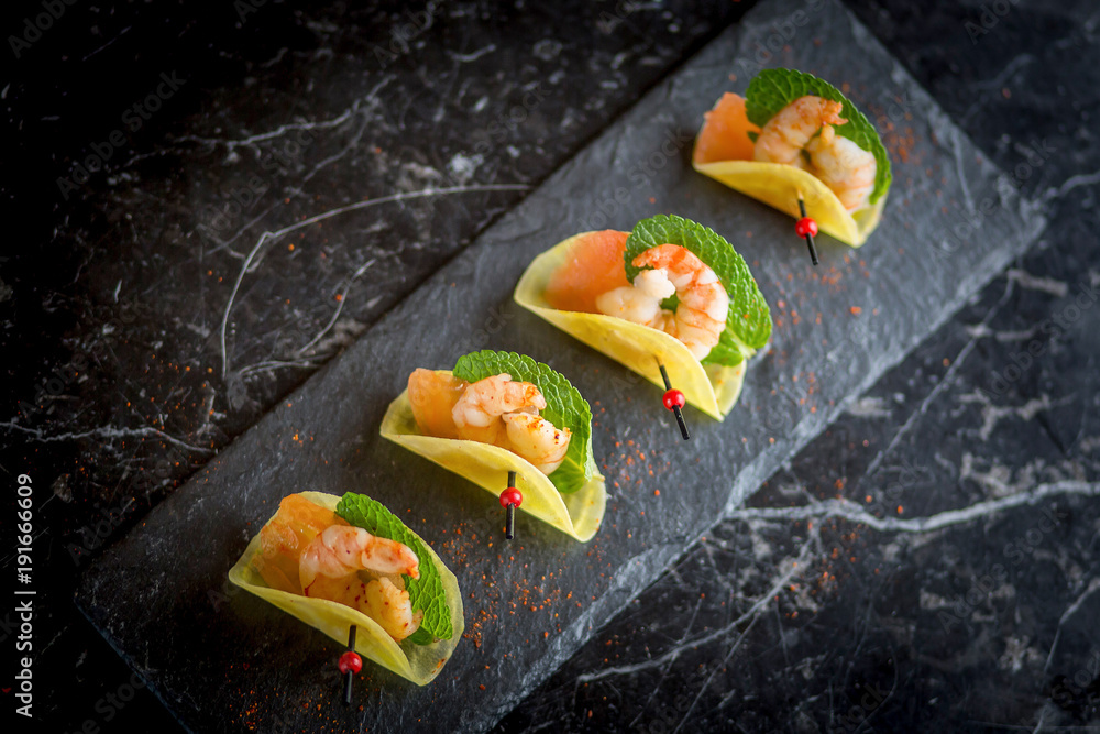 shrimp appetizers on black plate