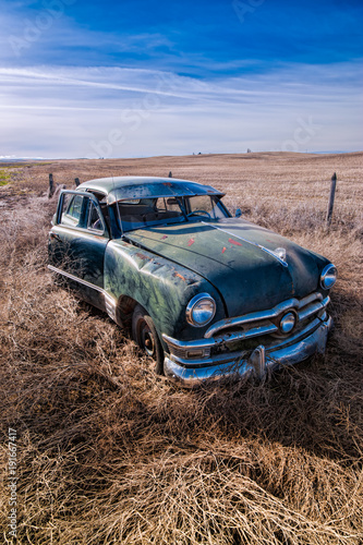 Old rusted classic car in Washington field.