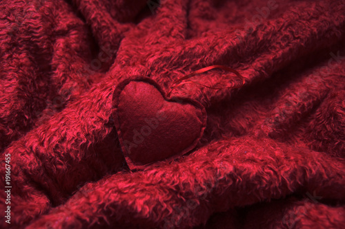 red heart on fluffy red blanket
