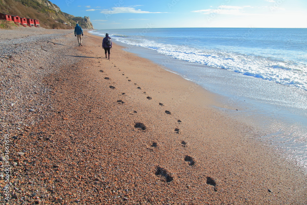 Footprints on the pebble beach in Branscombe, Devon Footprints on the pebble beach in Branscombe, Devon