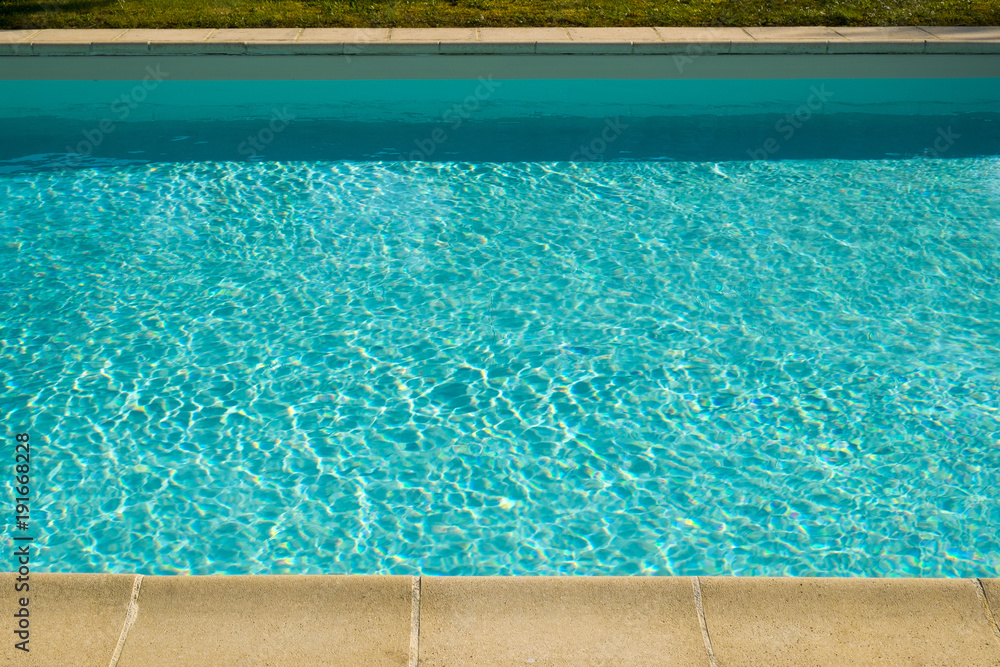 Textured light effect on the surface ripples of an outdoor swimming pool