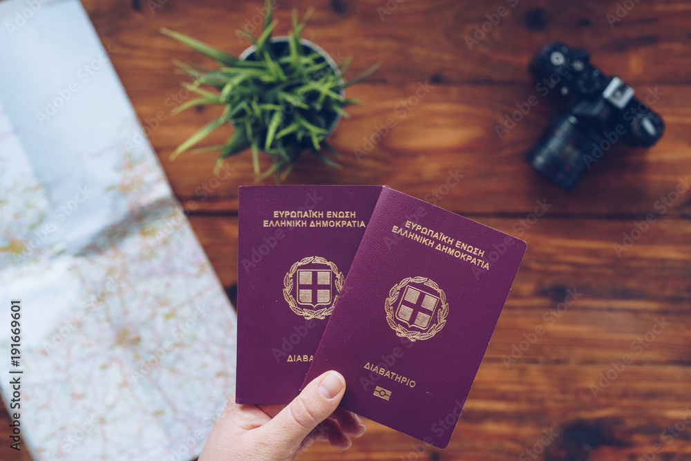 Fototapeta premium Greek passports and map of Europe, top view