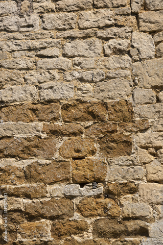 An old weathered stone wall needs repairs. Construction full frame texture background.