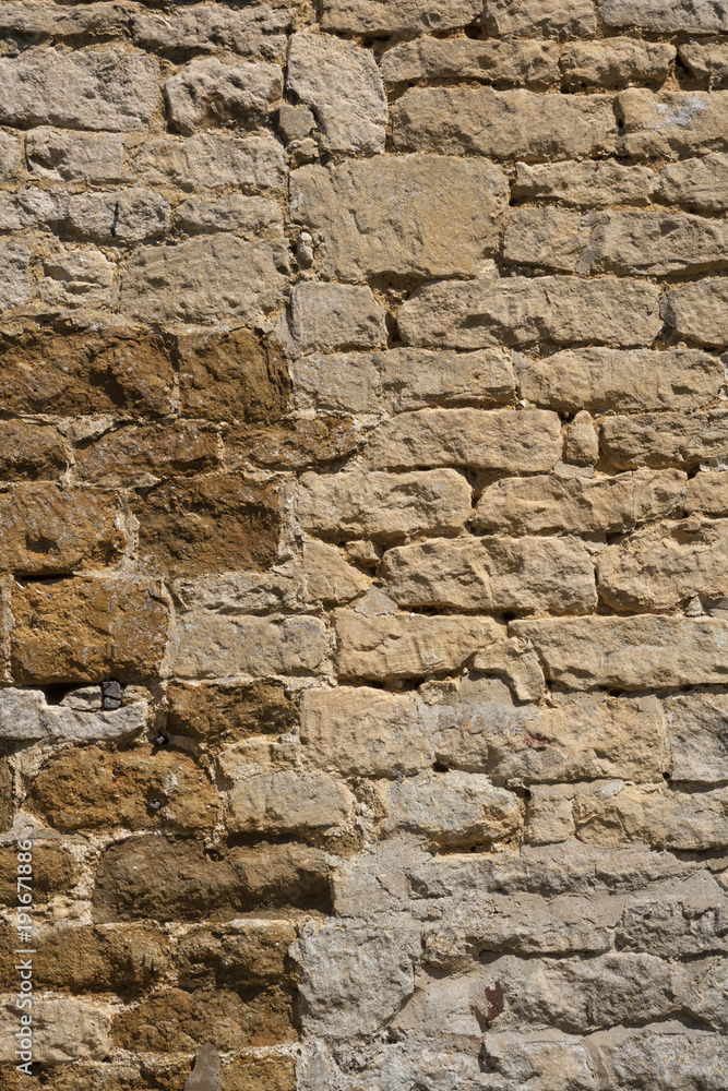 An old weathered stone wall needs repairs. Construction full frame texture background. An old weathered stone wall needs repairs. Construction full frame texture background.