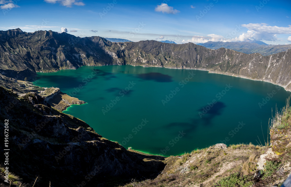 Panoramic of the volcano lake of Quilotoa, Ecuador. With a little kayak inside