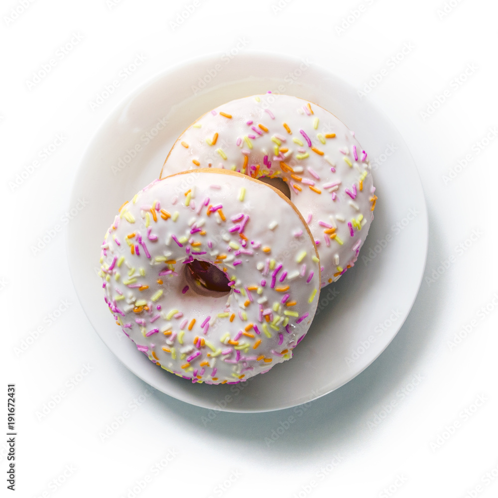 Donut on a plate and on a white background. Photo of sweets. Top view. Copy space. Mock-up Donut on a plate and on a white background. Photo of sweets. Top view. Copy space. Mock-up