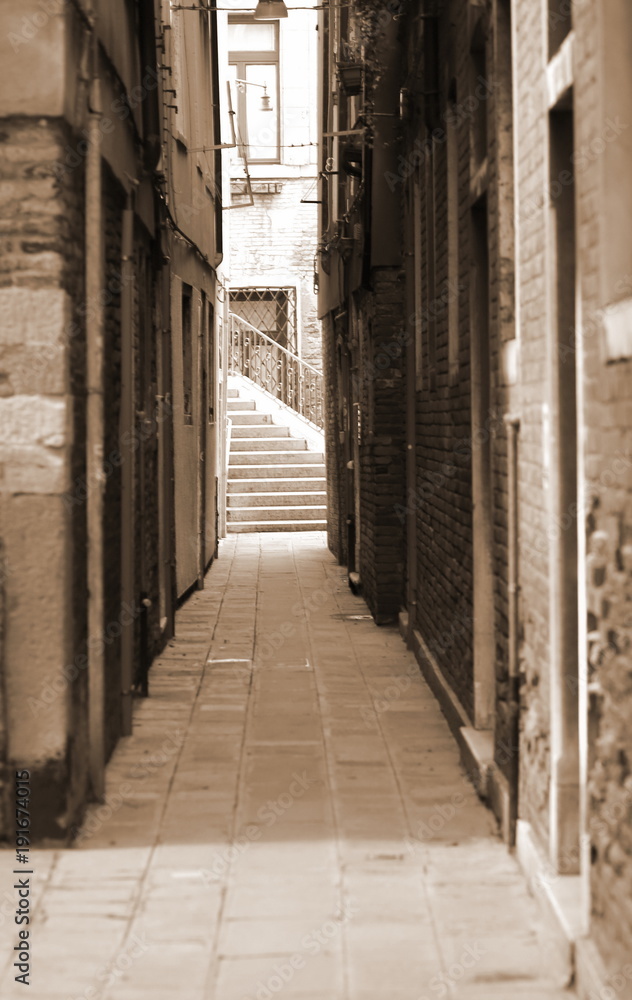 Naklejka premium street between tall houses in Venice Italy