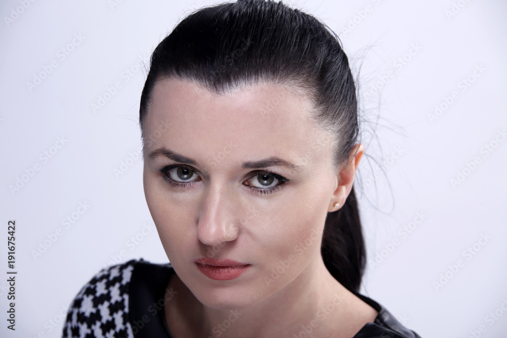 Naklejka premium Portrait of the young beautiful woman of the brunette with green eyes.