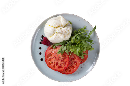 Cheese of the original form with tomatoes on a white background.