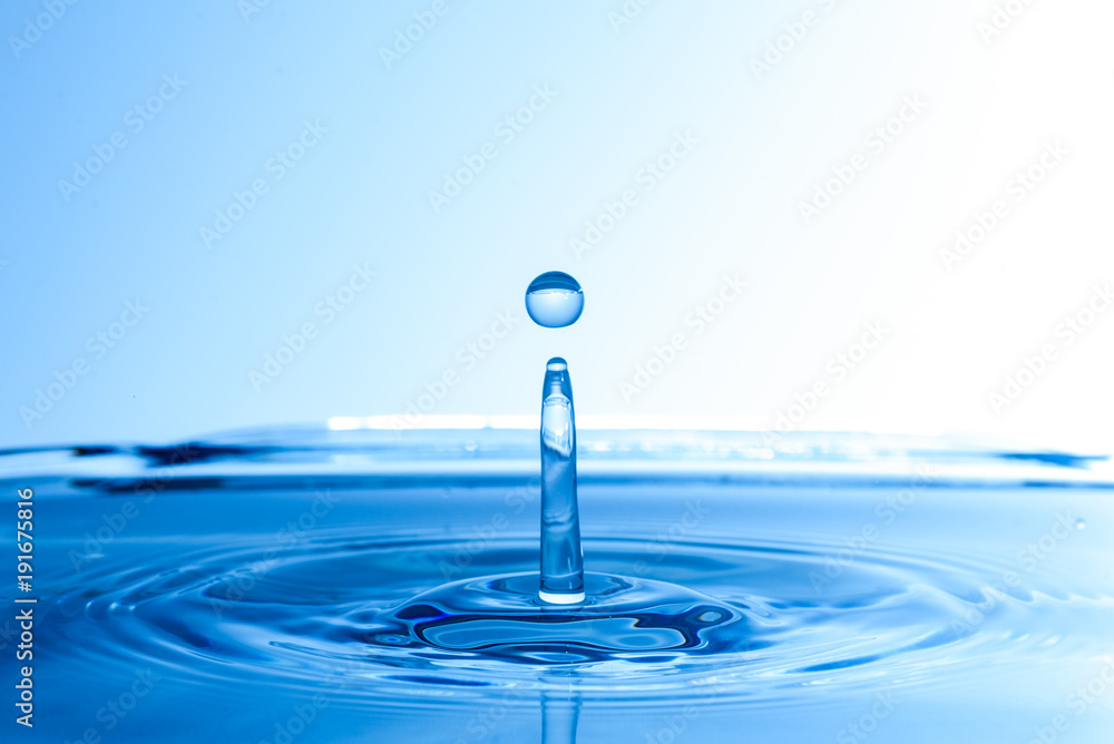 Water drop fall into water and splashes from surface Water drop fall into water and splashes from surface