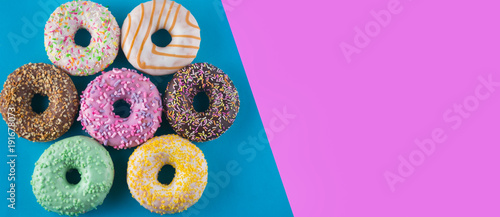 Set of doughnuts on blue and purple background. photo