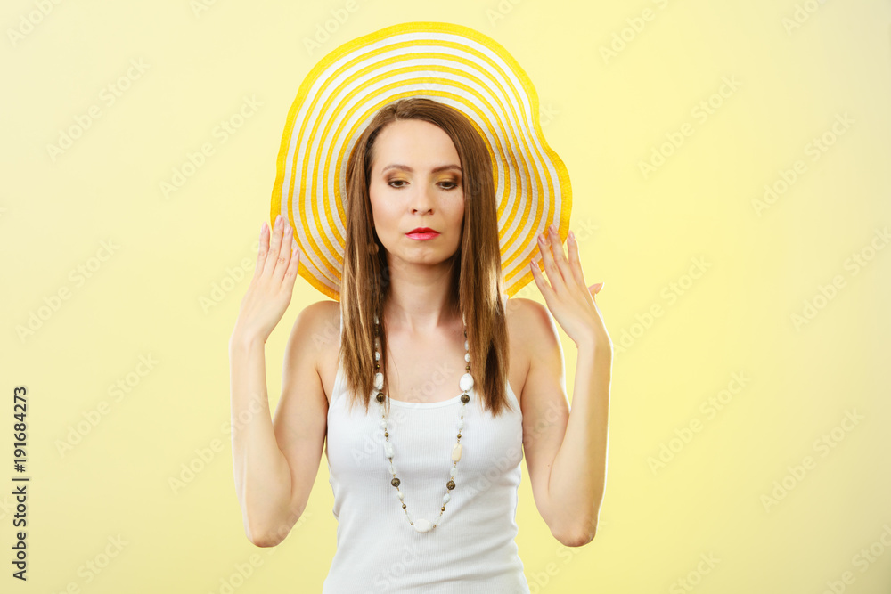 Woman in big yellow summer hat.