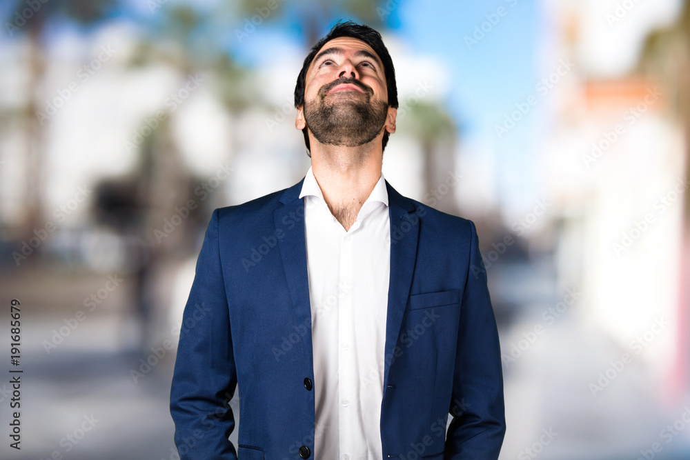 Handsome man looking up on unfocused background Handsome man looking up on unfocused background