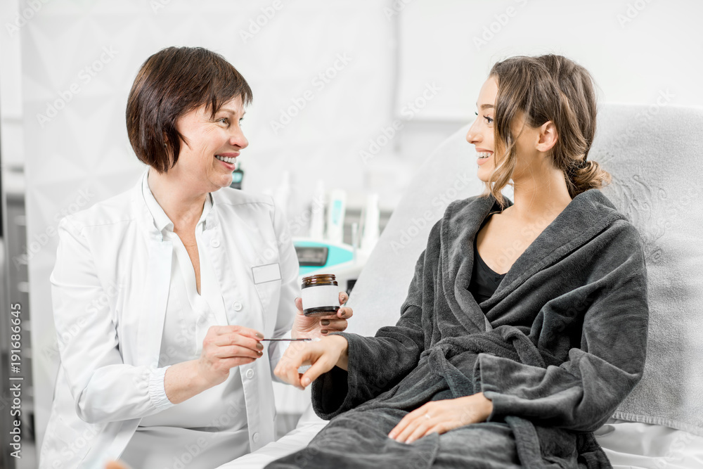 Senior doctor offering bio additives to a young patient in the medical resort Senior doctor offering bio additives to a young patient in the medical resort