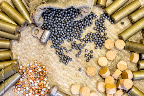hunting equipment on the background of an old sacking. Brass shells, hunting shot concept as background