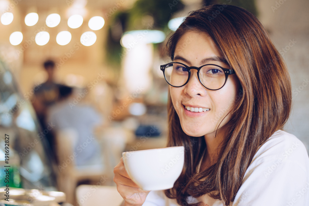 Portrait of asian women holding a cup of coffee in the cafe. Portrait of asian women holding a cup of coffee in the cafe.