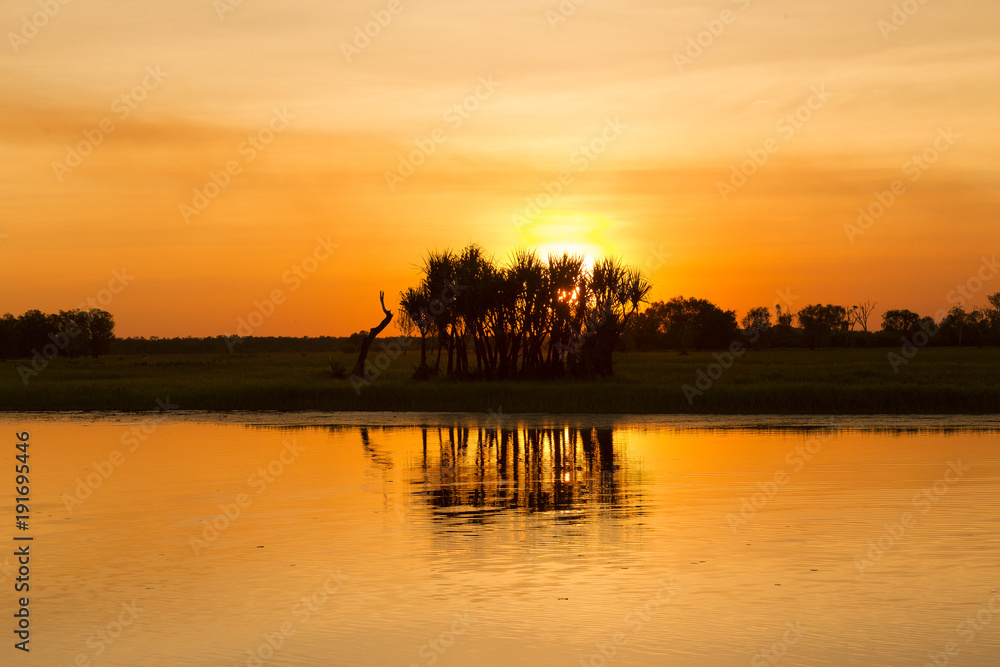 Sunset behind trees on Yellow Waters Billabong, Kakadu National Park, Northern Territory Australia.