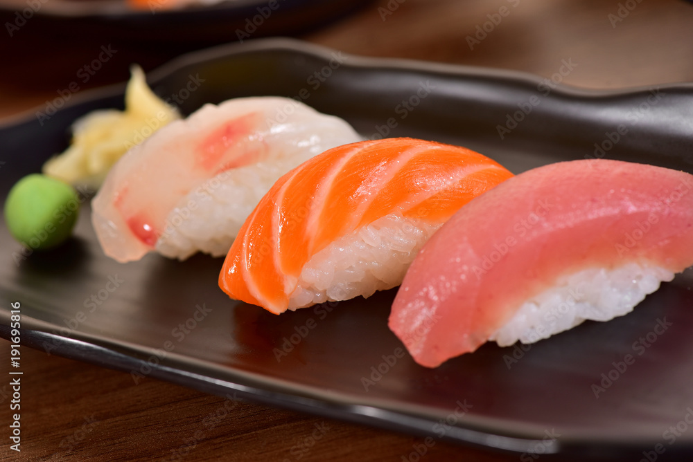 Salmon and Tuna Nigiri Sushis on restaurant table Salmon and Tuna Nigiri Sushis on restaurant table