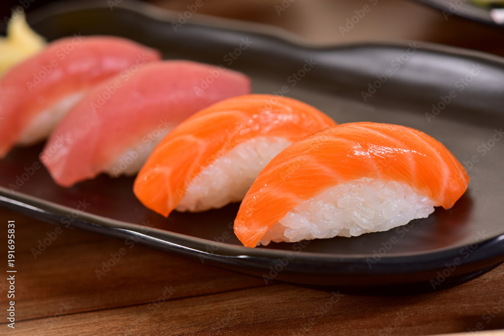 Salmon and Tuna Nigiri Sushis on restaurant table Salmon and Tuna Nigiri Sushis on restaurant table