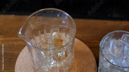 Expert barman is making cocktail at bar photo