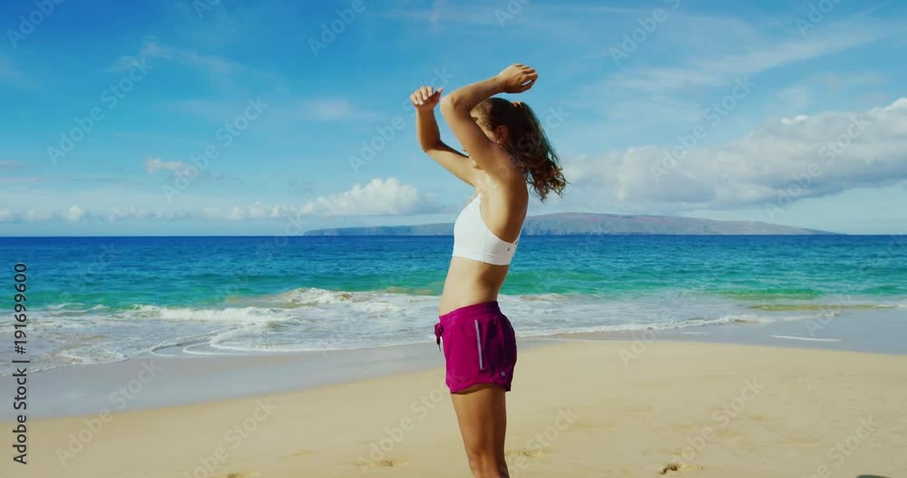 Athletic young woman running on the beach Athletic young woman running on the beach