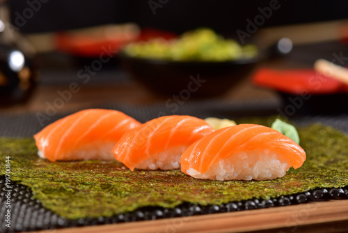 Salmon nigiri sushis on top of a seaweed
