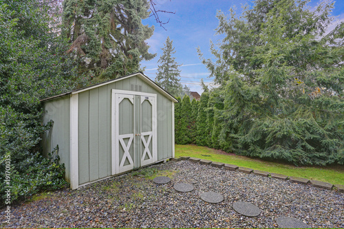 Backyard shed with lots of trees around photo