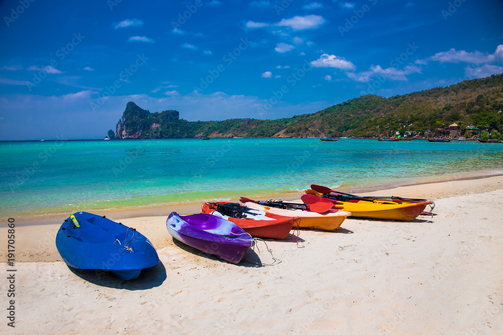 Colorful kayaks at Ao Loh Dalum beach on Phi Phi Don Island, Thailand.