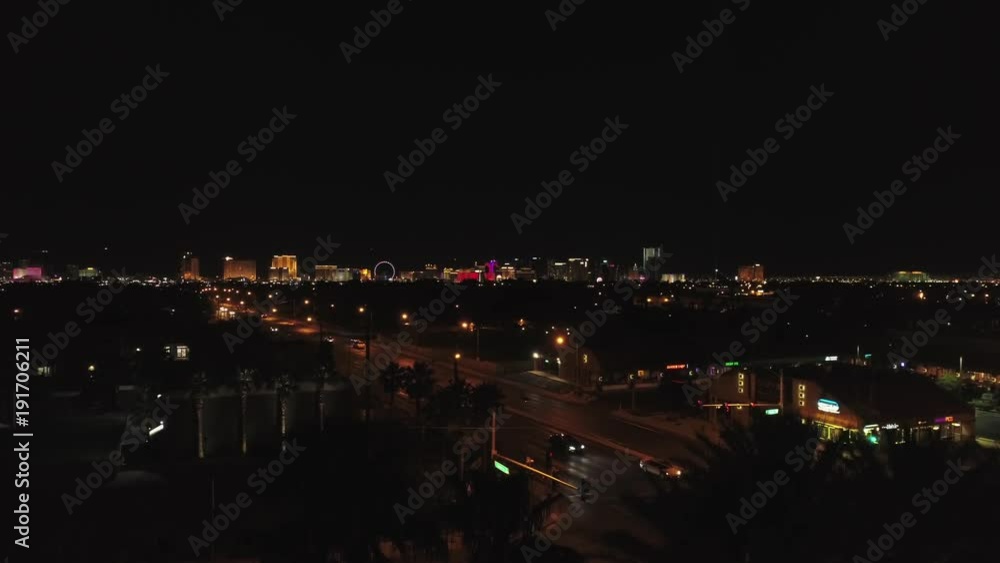 Aerial establishing shot Las Vegas city bright lights at night ascending Aerial establishing shot Las Vegas city bright lights at night ascending