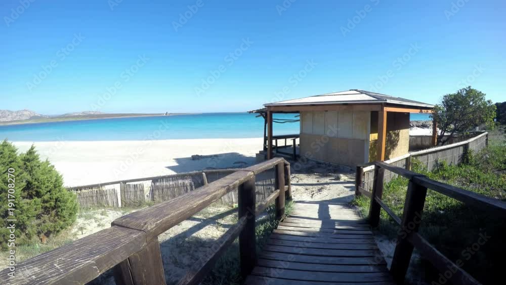 Wooden boardwalk leading to a beach bar in Stintino. Sardinia, Italy Wooden boardwalk leading to a beach bar in Stintino. Sardinia, Italy