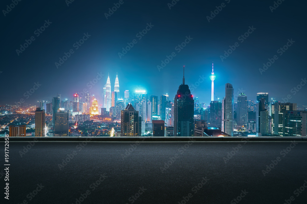 Fototapeta premium Asphalt road side with beautiful Kuala Lumpur city skyline. Night scene .