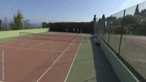 Wallpaper Mural Panoramic view of people playing tennis outdoors, training before competition Torontodigital.ca