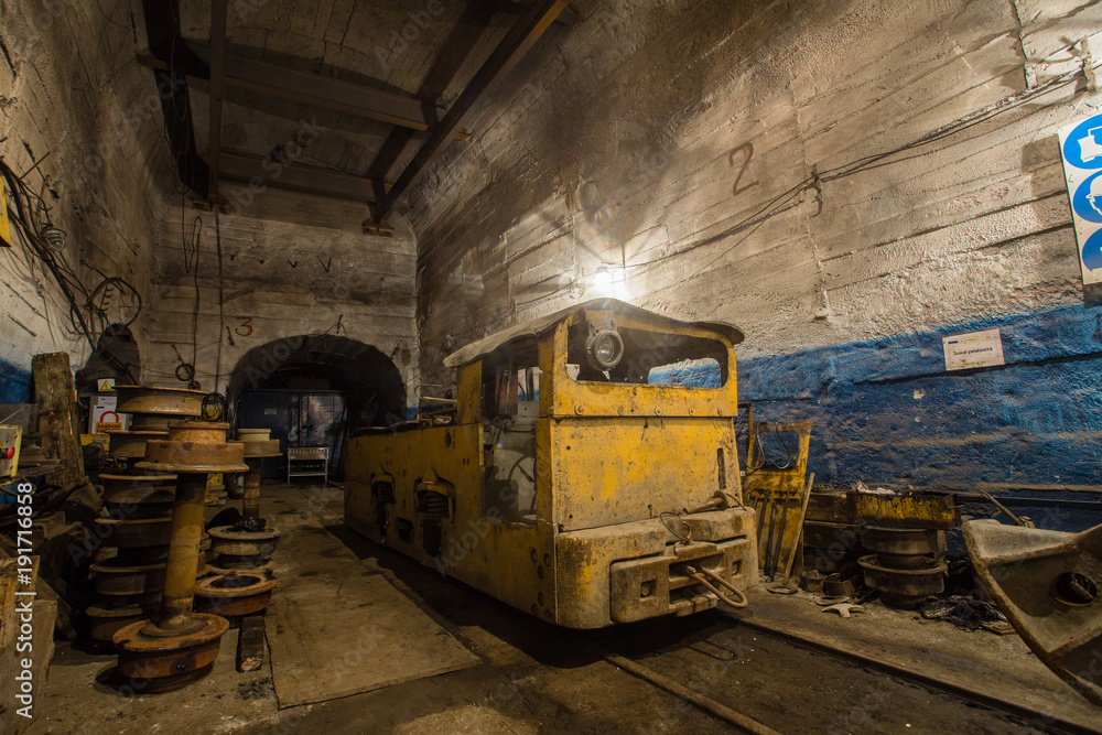 Underground ore mine shaft tunnel gallery with electrical locomotive room