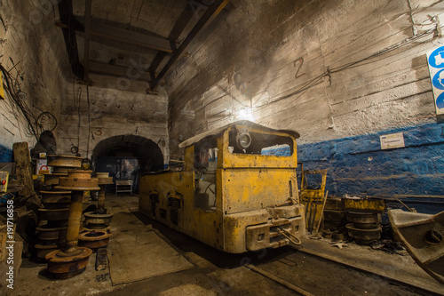 Underground ore mine shaft tunnel gallery with electrical locomotive room