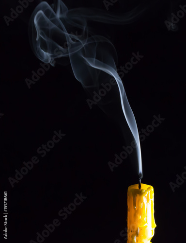 Yellow Candle and white smoke on black background