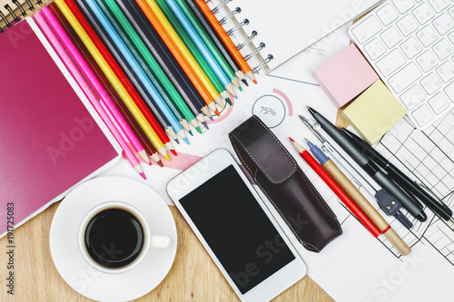 Modern desk top with smartphone and supplies