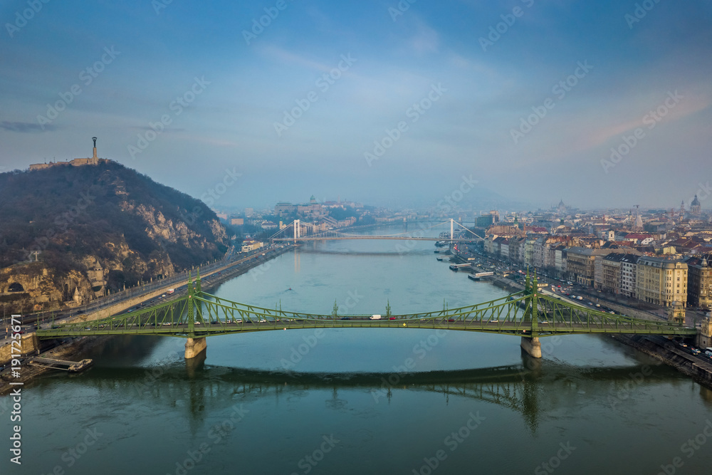 Budapest, Hungary - Panoramic aerial view of Budapest early in the morning with Libety Bridge, Gellert Hill, Citadella with Statue of Liberty, Buda Castle and Elisabeth Bridge with blue sky