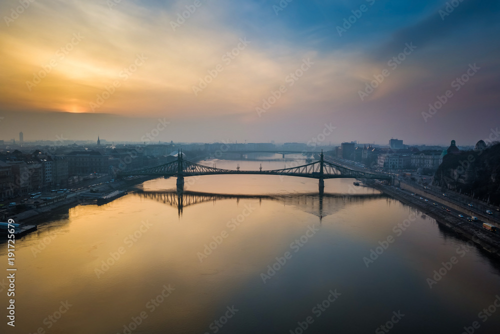 Budapest, Hungary - Aerial panoramic skyline view of Liberty Bridge over River Danube at sunrise with beautiful sky and clouds